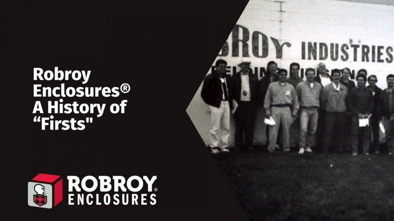 Black and white image of a Group of individuals standing in front of the Robroy Industries logo