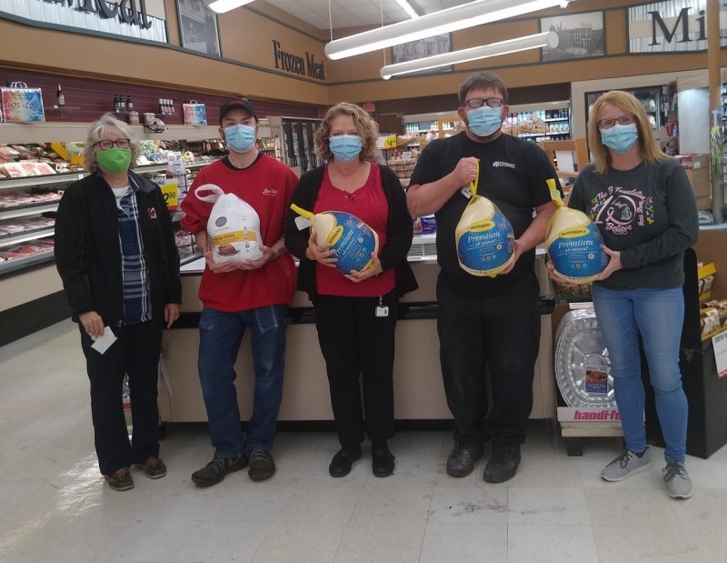 Cindy Stowell from Robroy Enclosures presents Thankgiving turkeys to the B Foundation, an organization that assists persons with cancer.