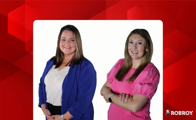 A red abstract background with two people in the front. Tawny Metz and Laci Hasler. 
