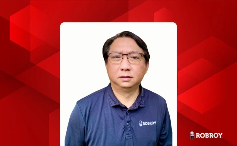 Red abstract background with white box in the middle, a man wearing a Robroy shirt is seen over the white box with the Robroy logo to the right of the image.